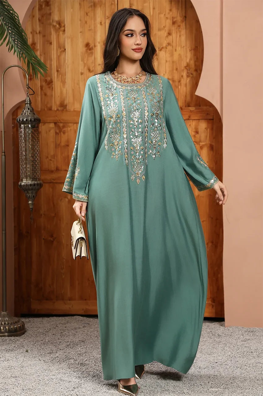 Full-length editorial shot of the Zahia Green Saudi Kaftan for luxury modest fashion occasions.