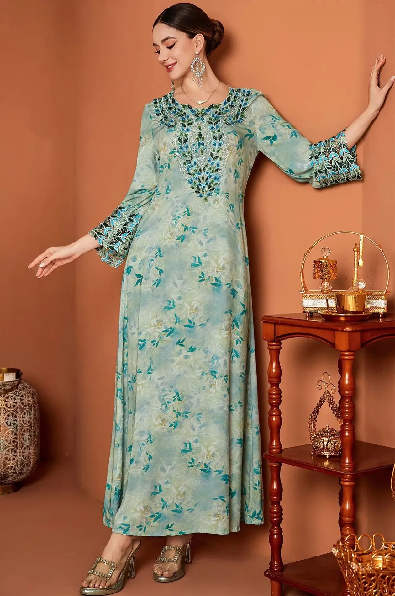 Full-length lifestyle shot of the Zahri Mint Kaftan in a luxury interior.