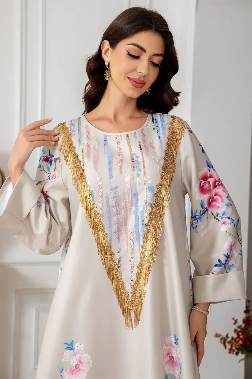 Close-up of gold sequins and metallic V-fringe on Zaree kaftan.