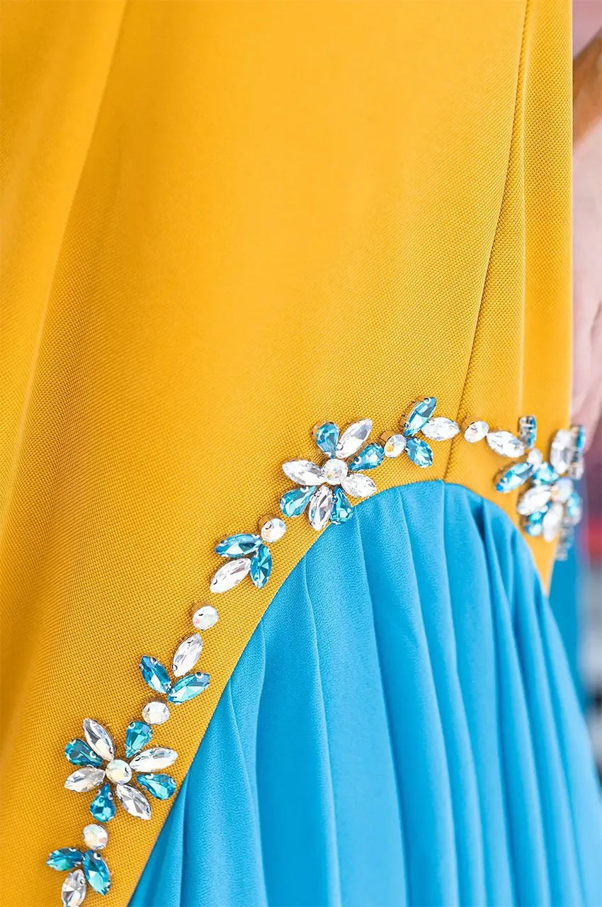 High-resolution shot of the jeweled Sfifa-style trim and crepe fabric texture on the Zayna kaftan.