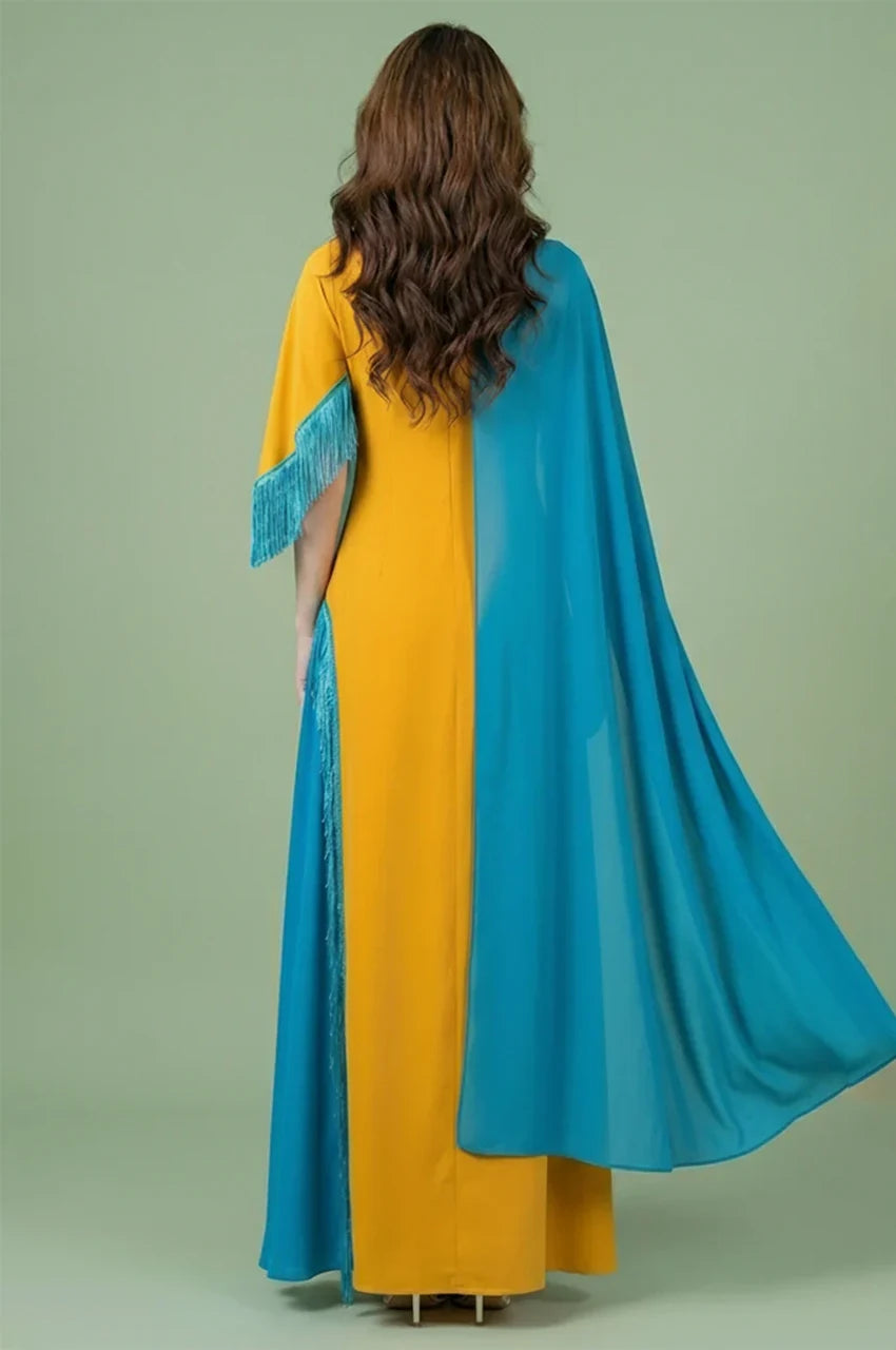 Back view of Zayna kaftan cape showing fluid teal chiffon overlay and floor-length silhouette.