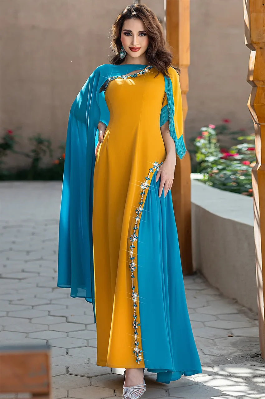 Zayna kaftan cape in mustard and teal shown in natural outdoor lighting at Naylara.