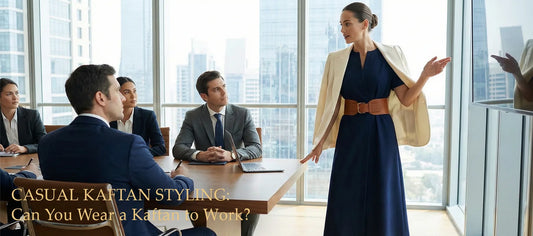 Woman wearing a navy blue casual kaftan styled with a white blazer and leather belt presenting in a corporate boardroom. Text overlay reads: Casual Kaftan Styling: Can You Wear a Kaftan to Work?