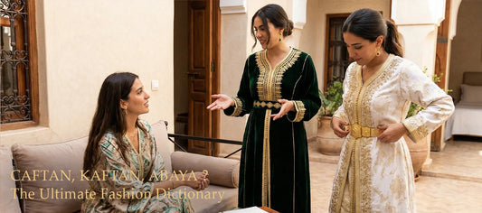 Three women comparing styles: a printed Western resort caftan, a green velvet Moroccan Kaftan, and a white wedding Takchita with a gold belt.