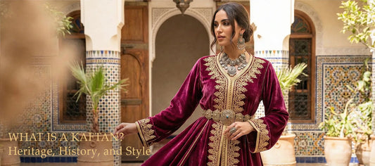 Header banner for the guide "What Is a Kaftan" featuring a woman in a burgundy velvet Moroccan Takchita with gold embroidery and heavy silver jewelry.