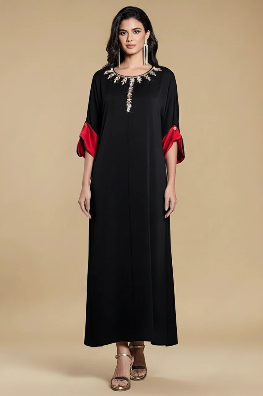 Full front view of Adara black satin kaftan dress with embellished neckline and red cuffs