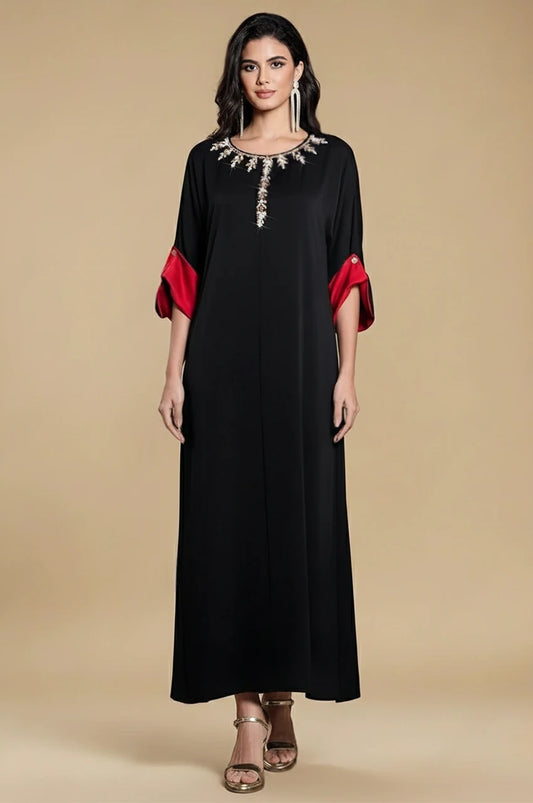 Full front view of Adara black satin kaftan dress with embellished neckline and red cuffs
