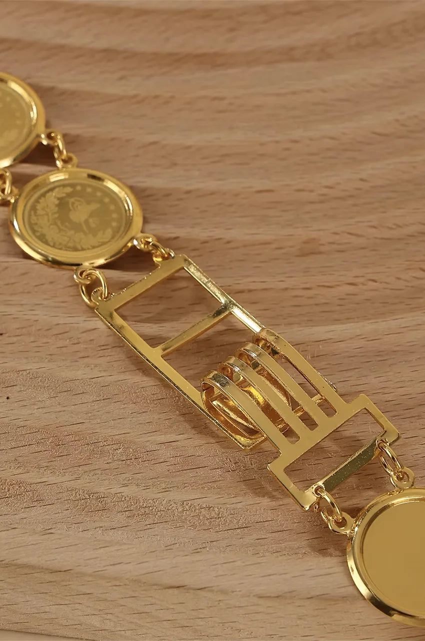 Close-up of the durable gold metal hook-and-slot clasp mechanism on the coin belt.