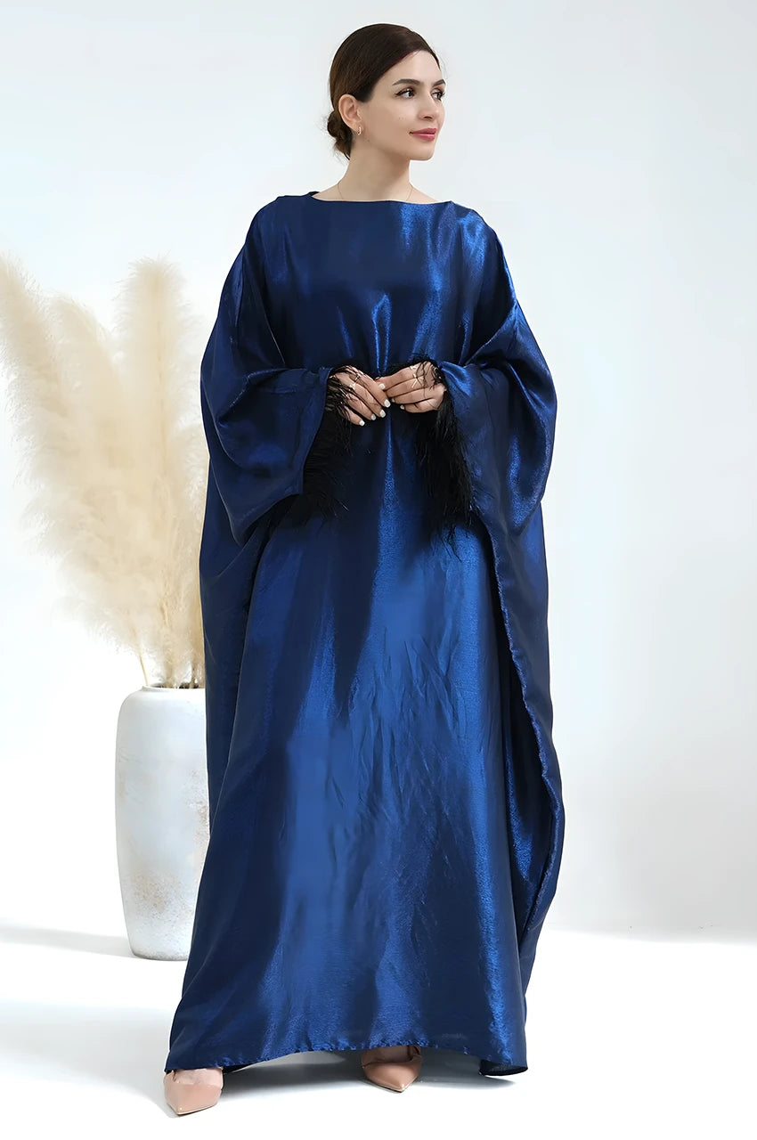 Fashion shot of blue satin Alara kaftan gown with boat neckline