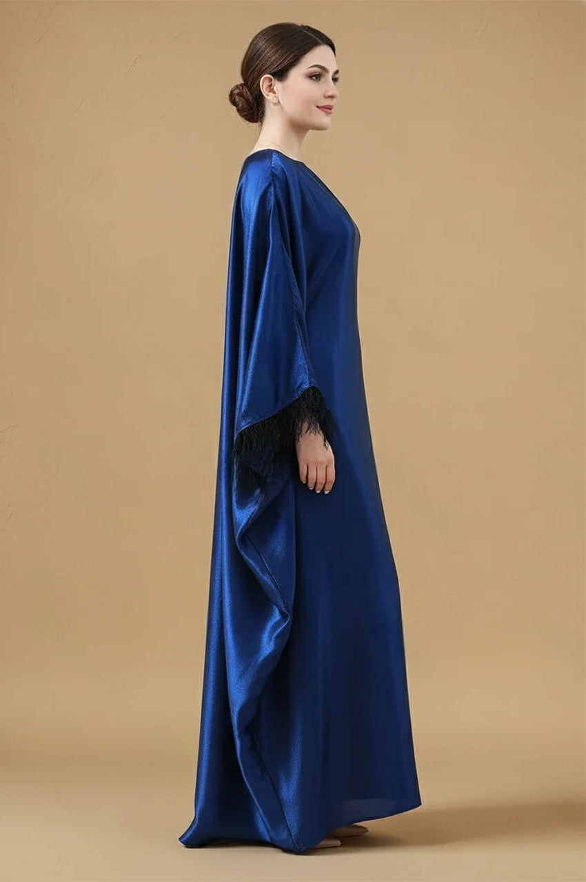 Side view of ALARA satin kaftan gown in blue with flowing draped sleeves