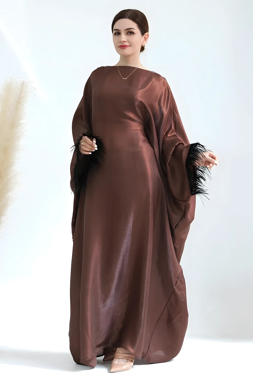 Close-up of black feather cuffs on brown Alara satin kaftan gown
