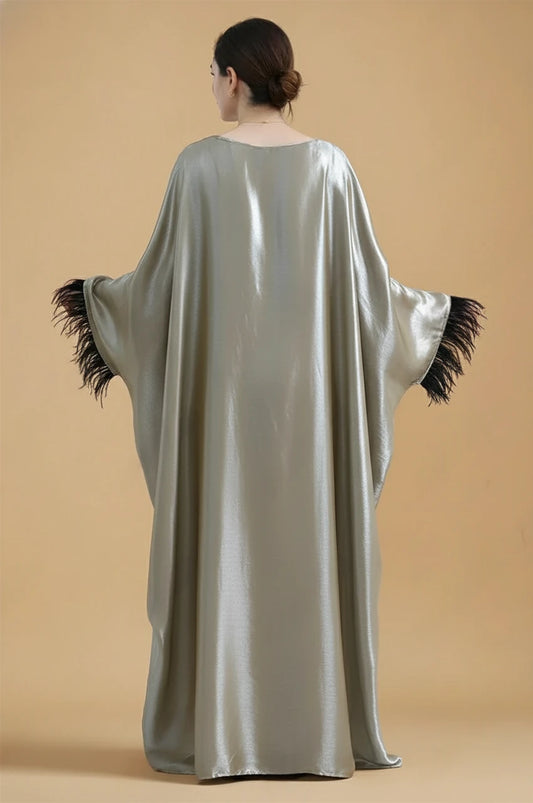 Back view of ALARA green satin kaftan gown with wide draped sleeves