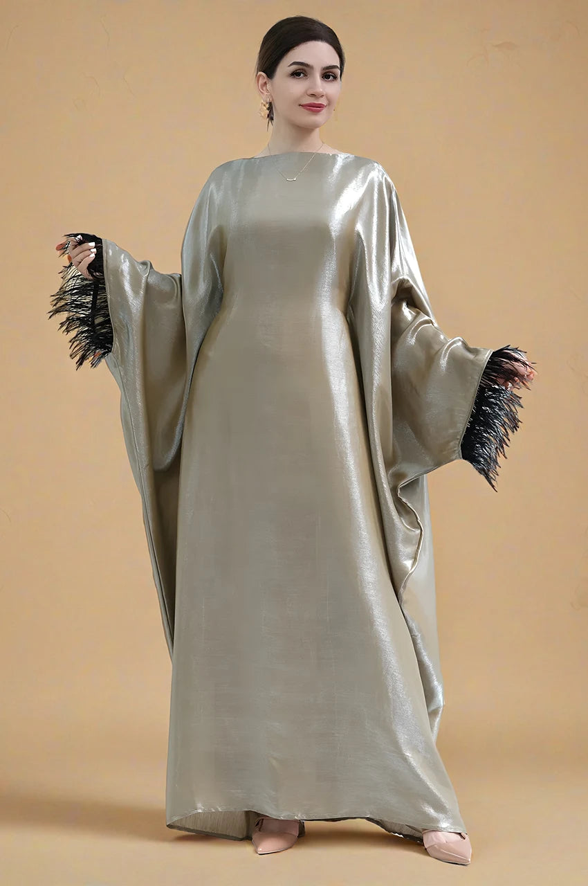 Green satin kaftan gown ALARA with flowing sleeves and black feather trim