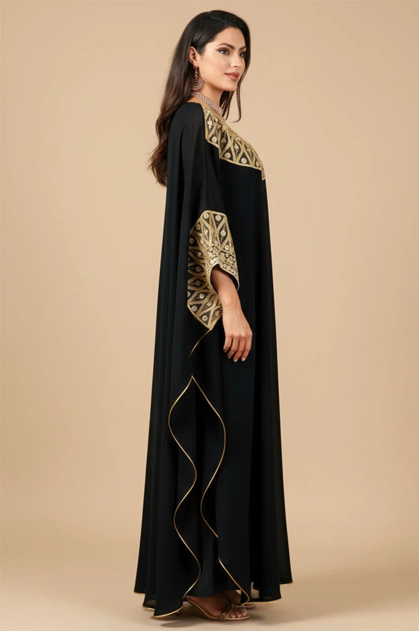 Side profile showing batwing sleeve drape on Aliya black dress.