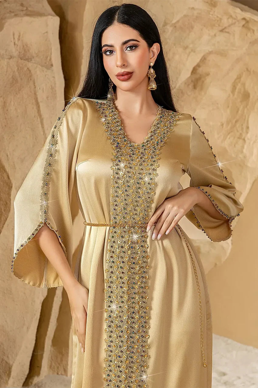 Half-profile outdoor shot of Almira champagne kaftan with intricate beadwork