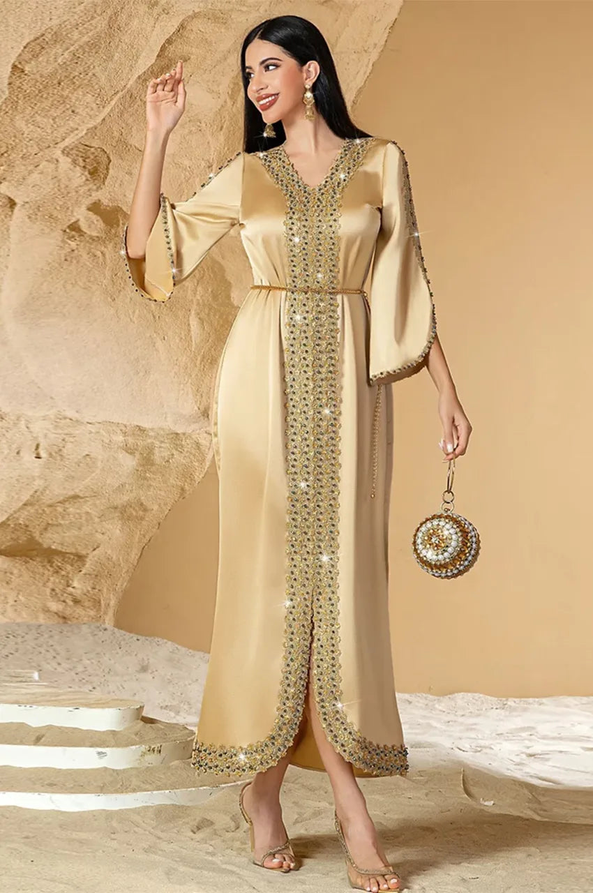 Walking outdoor view of Almira champagne kaftan highlighting flowing satin movement