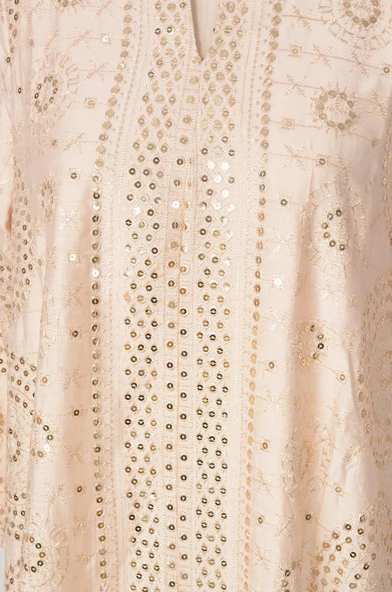 Close-up macro shot of the hand-placed mirrors and silver thread embroidery on the Aluna beige kaftan fabric.