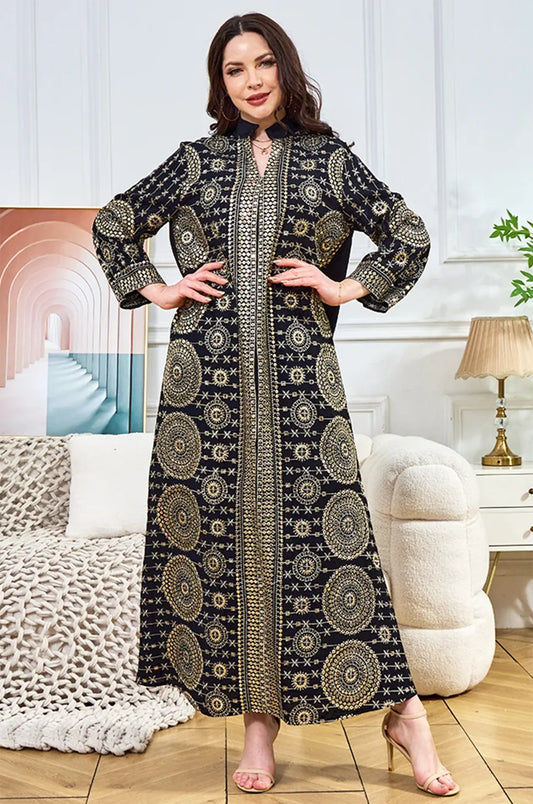 Model posing in the Aluna black mirror kaftan, showcasing the luxurious reflective patterns in a lifestyle setting.