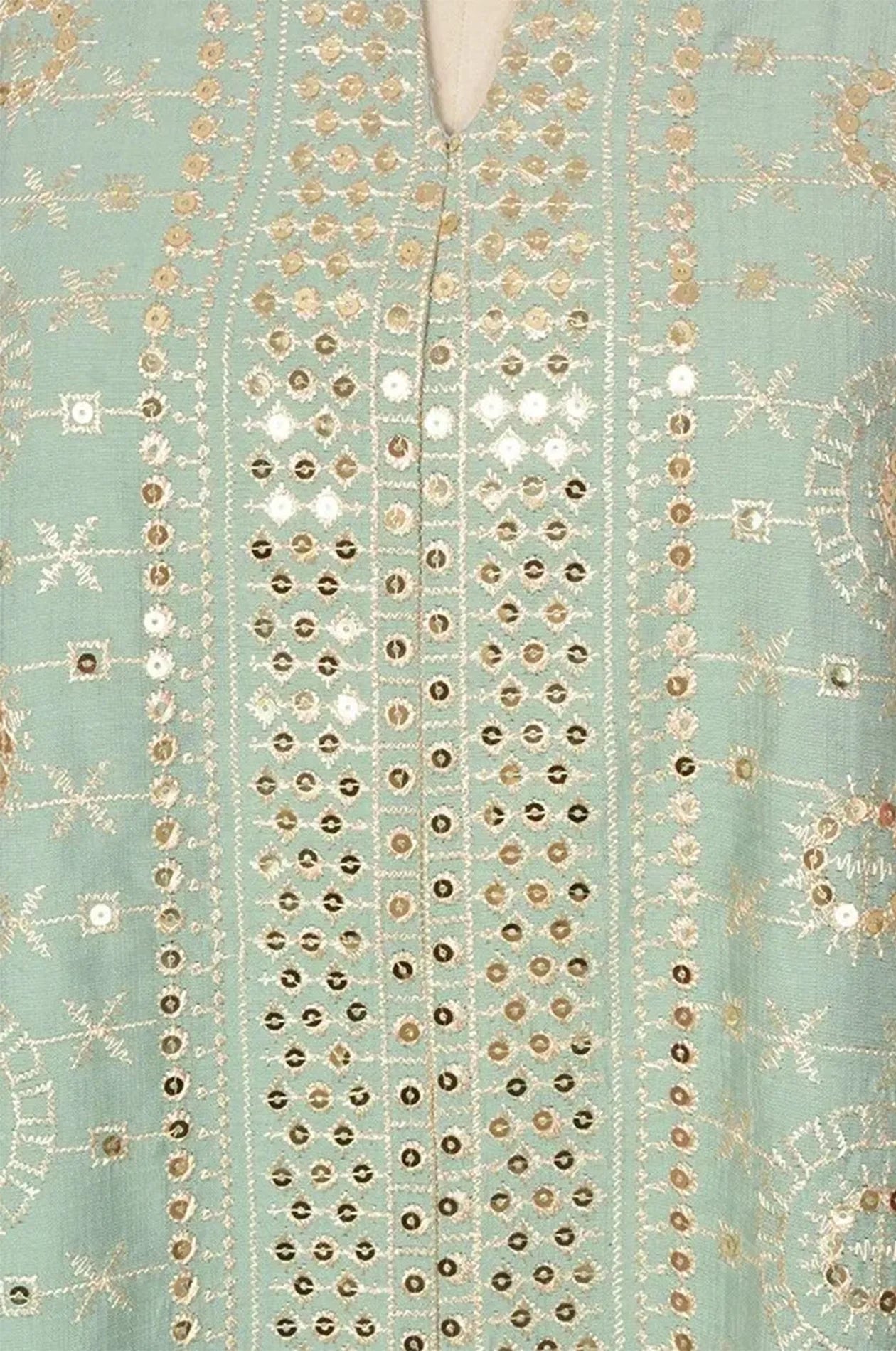 Close-up of the shimmering gold mirror work and intricate embroidery on the Aluna light green kaftan fabric.