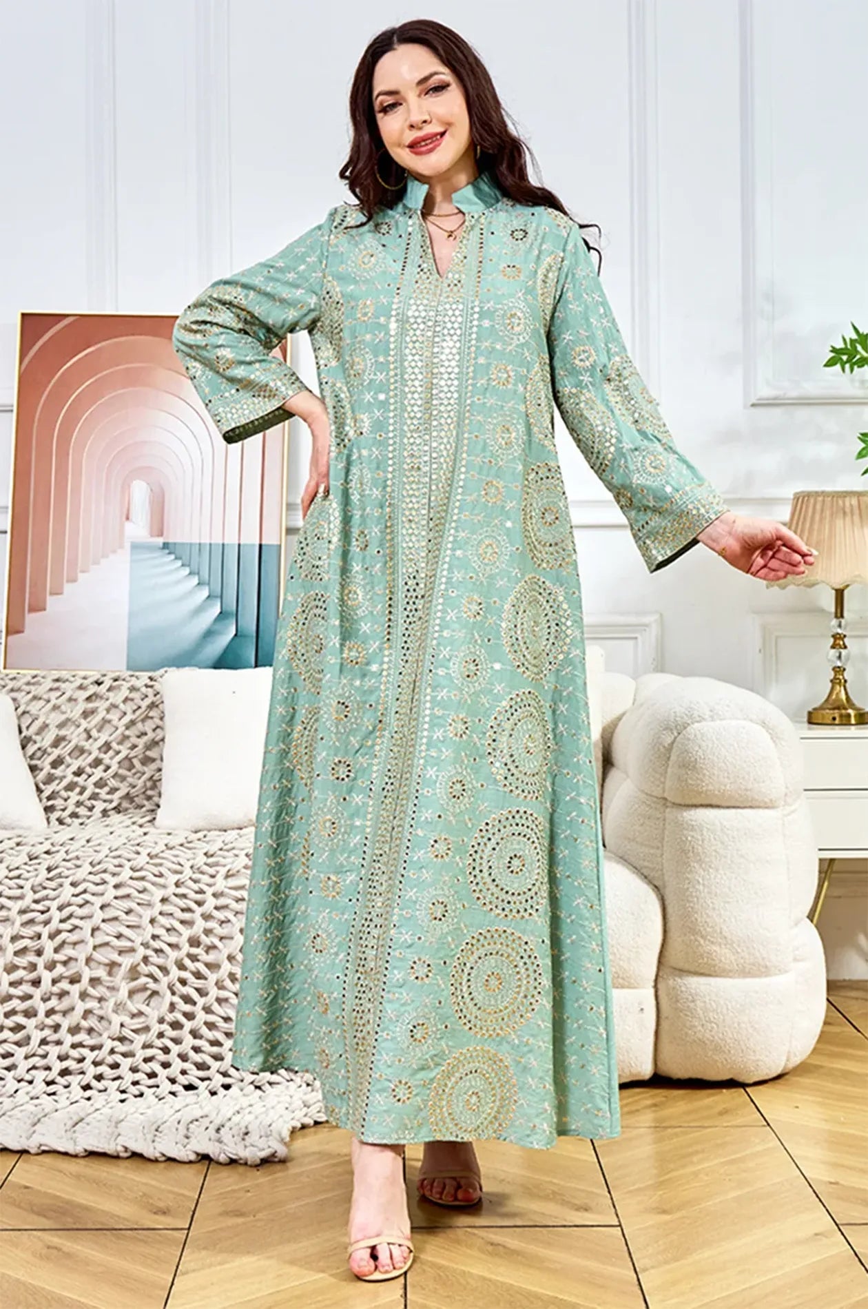 Elegant lifestyle shot of the Aluna light green mirror kaftan demonstrating the lightweight fabric and shimmering accents.