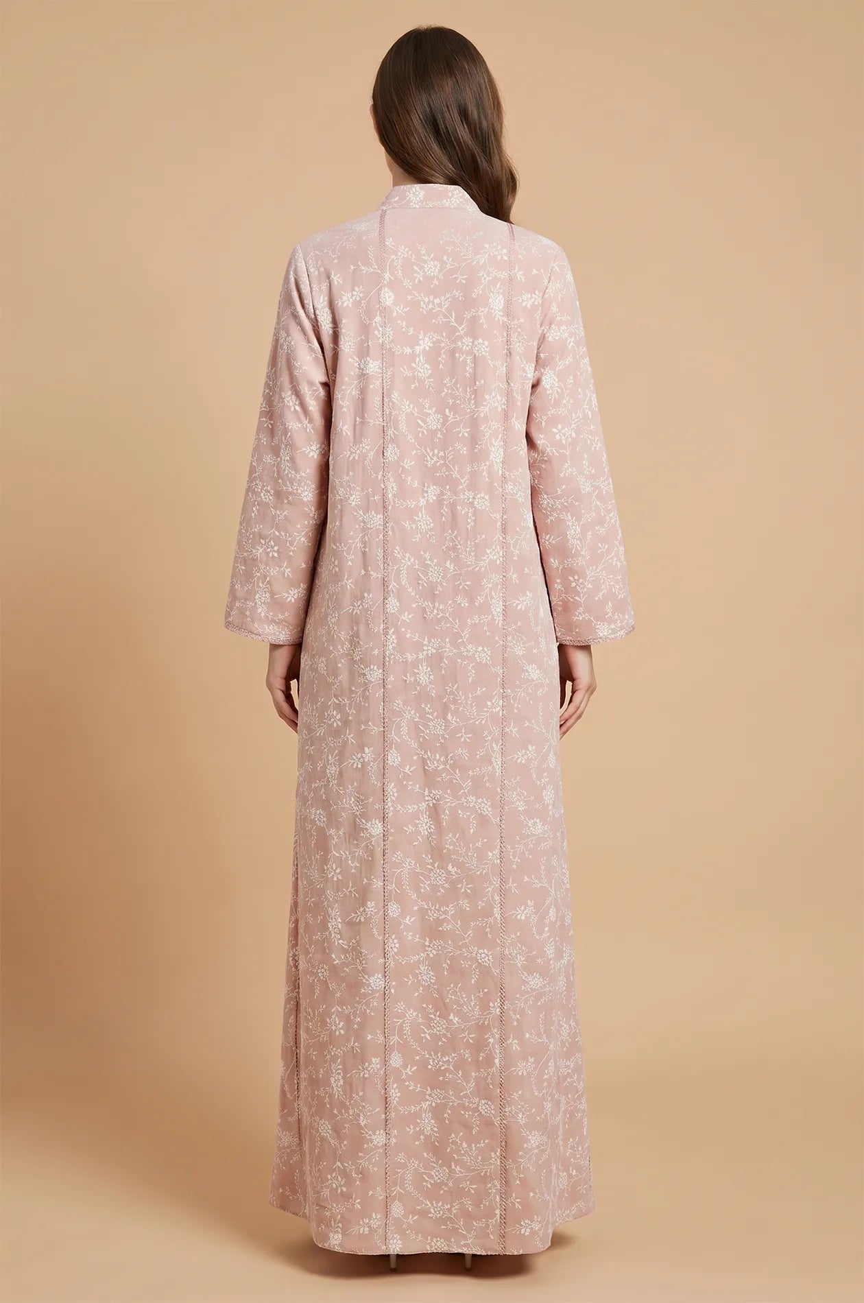 Rear view of the Alura pink shimmer kaftan showing the floor-length drape and all-over white floral vine patterns.
