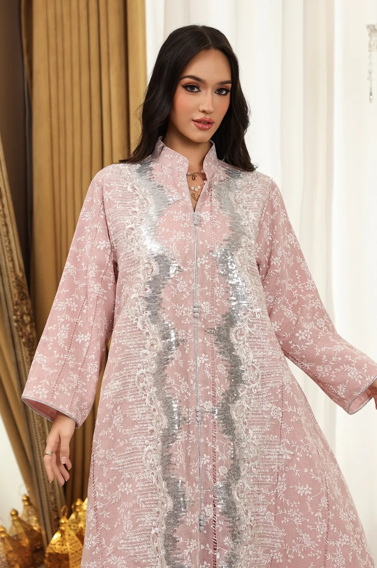 Portrait view of the pink Alura kaftan focusing on the structured mandarin collar and vertical sequin embellishments.