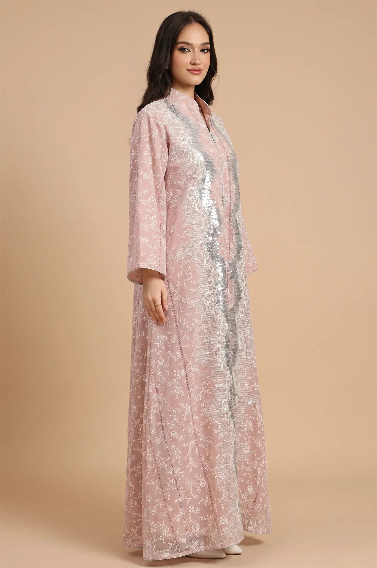 Three-quarter angle of the Alura pink shimmer kaftan highlighting the modest silhouette and shimmering silver sequin panels.