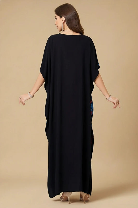 Back view of Amaya black embroidered cotton kaftan with flowing cotton fabric and wide sleeves