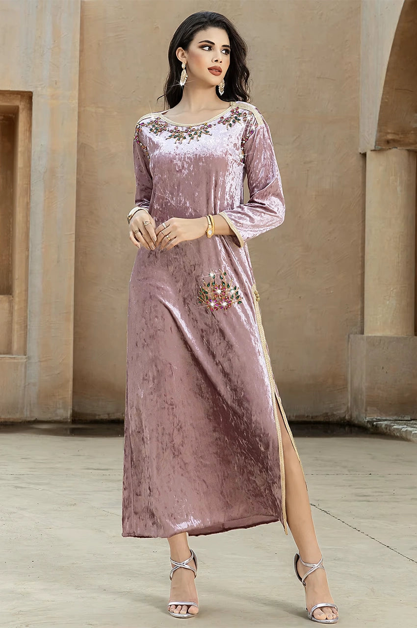 Elegant pose wearing the Amina pink velvet Pakistani kaftan with crystal floral embroidery