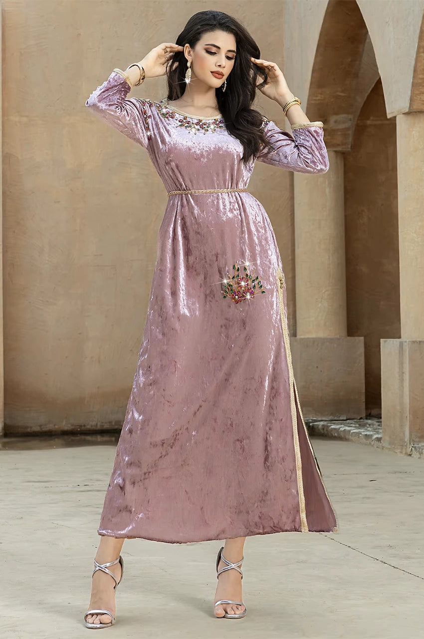 Fashion shot of Amina pink velvet Pakistani kaftan with gold waist trim and embellishments
