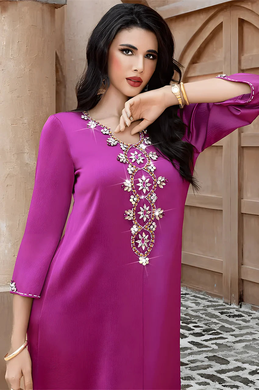 Closeup of model wearing Naylara Amira purple kaftan with crystal embellished neckline