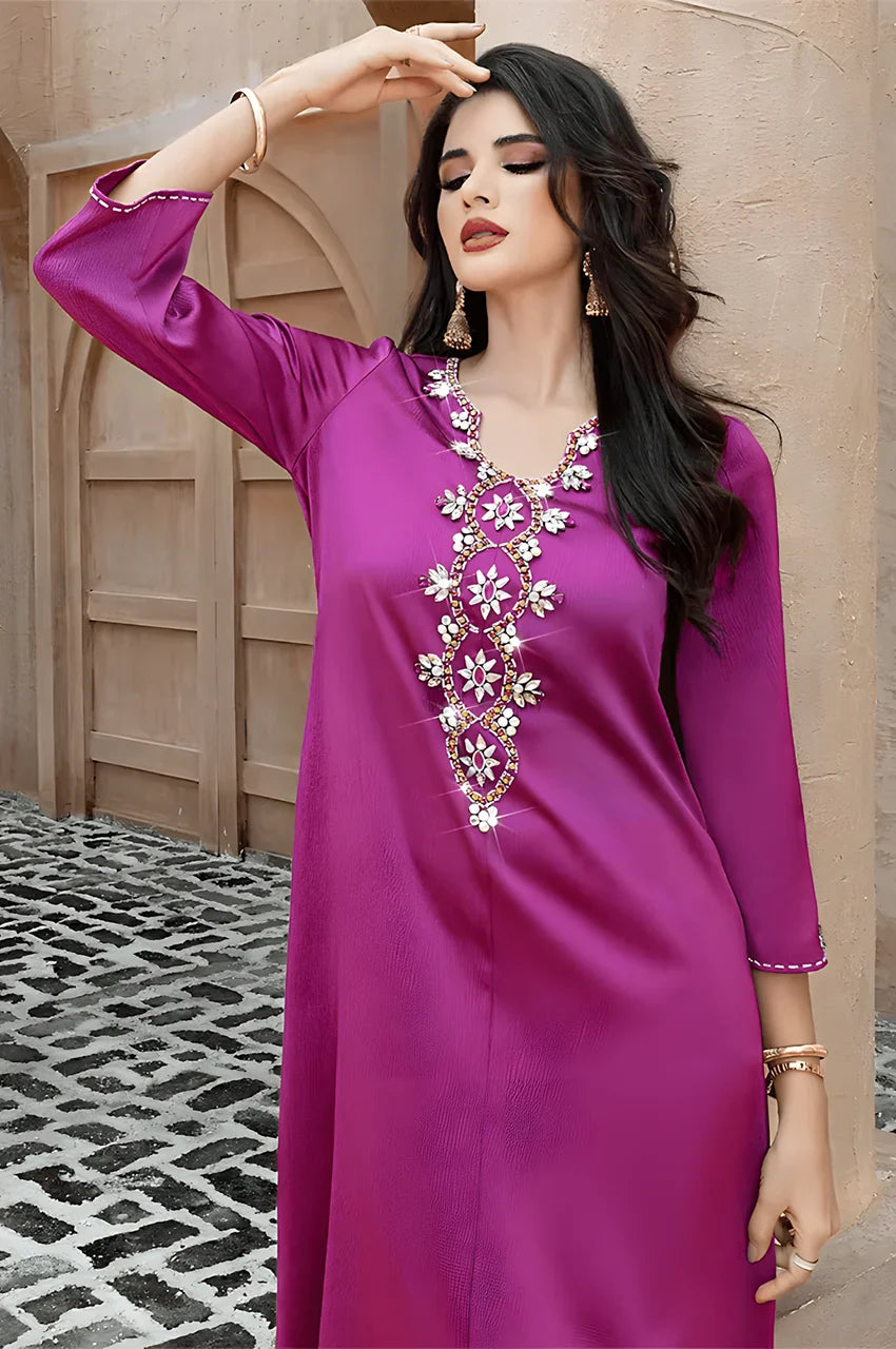 Model wearing Naylara Amira purple kaftan with embellished front panel outdoors
