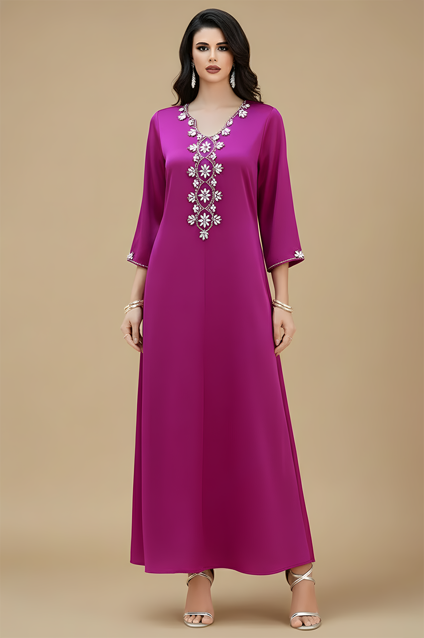 Studio three-quarter view of Naylara Amira purple kaftan on beige background