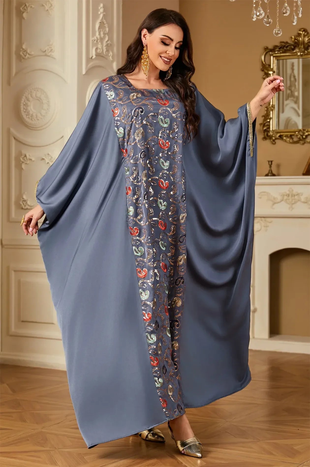 Dynamic movement shot of the gray Amiri farasha kaftan illustrating the lightweight and fluid drape of the garment.