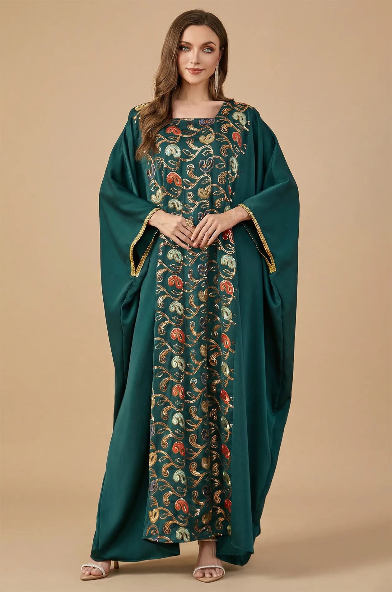 Full-length front view of the emerald green Amiri Farasha kaftan with colorful sequin embroidery by Naylara.