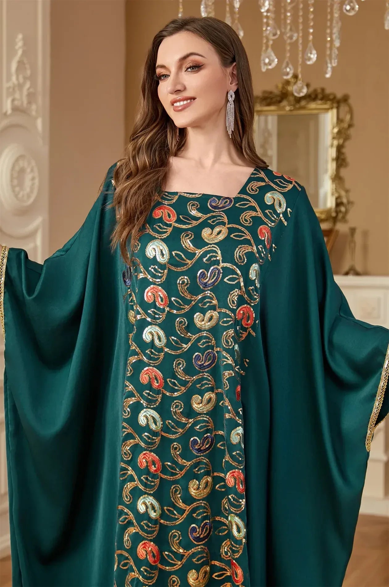 Close-up detail of the high-quality colorful sequin paisley embroidery on the green Amiri Farasha kaftan bodice.