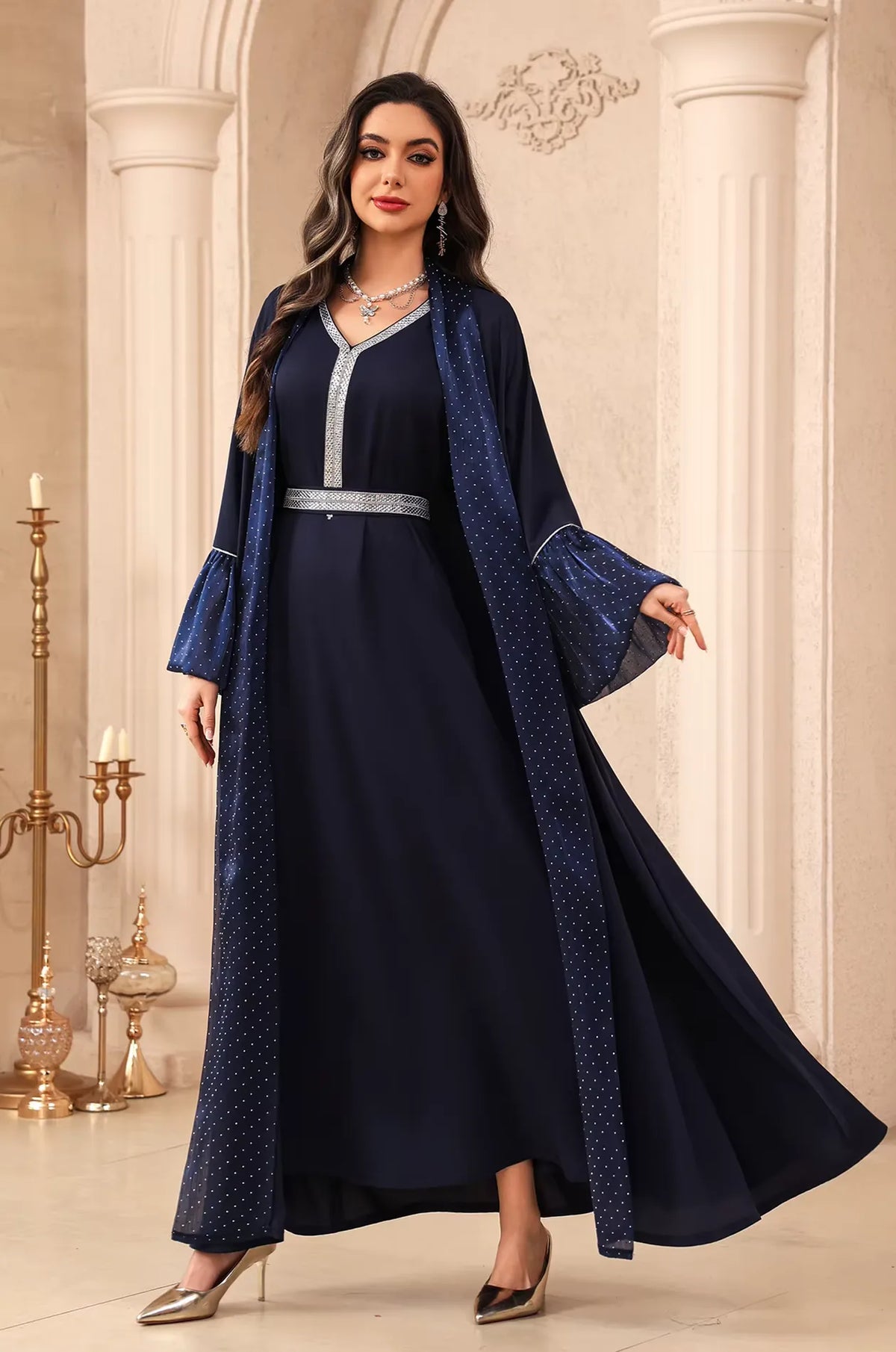 The Auris Blue solid color Kaftan in motion, showing the airy lightweight drape of the fabric and elegant movement.