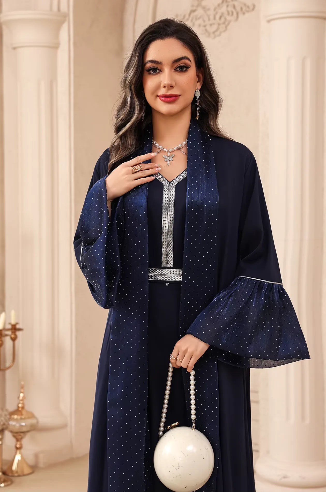Detail shot of the Auris Blue Kaftan focusing on the cinched rhinestone belt and luxury white accessory.