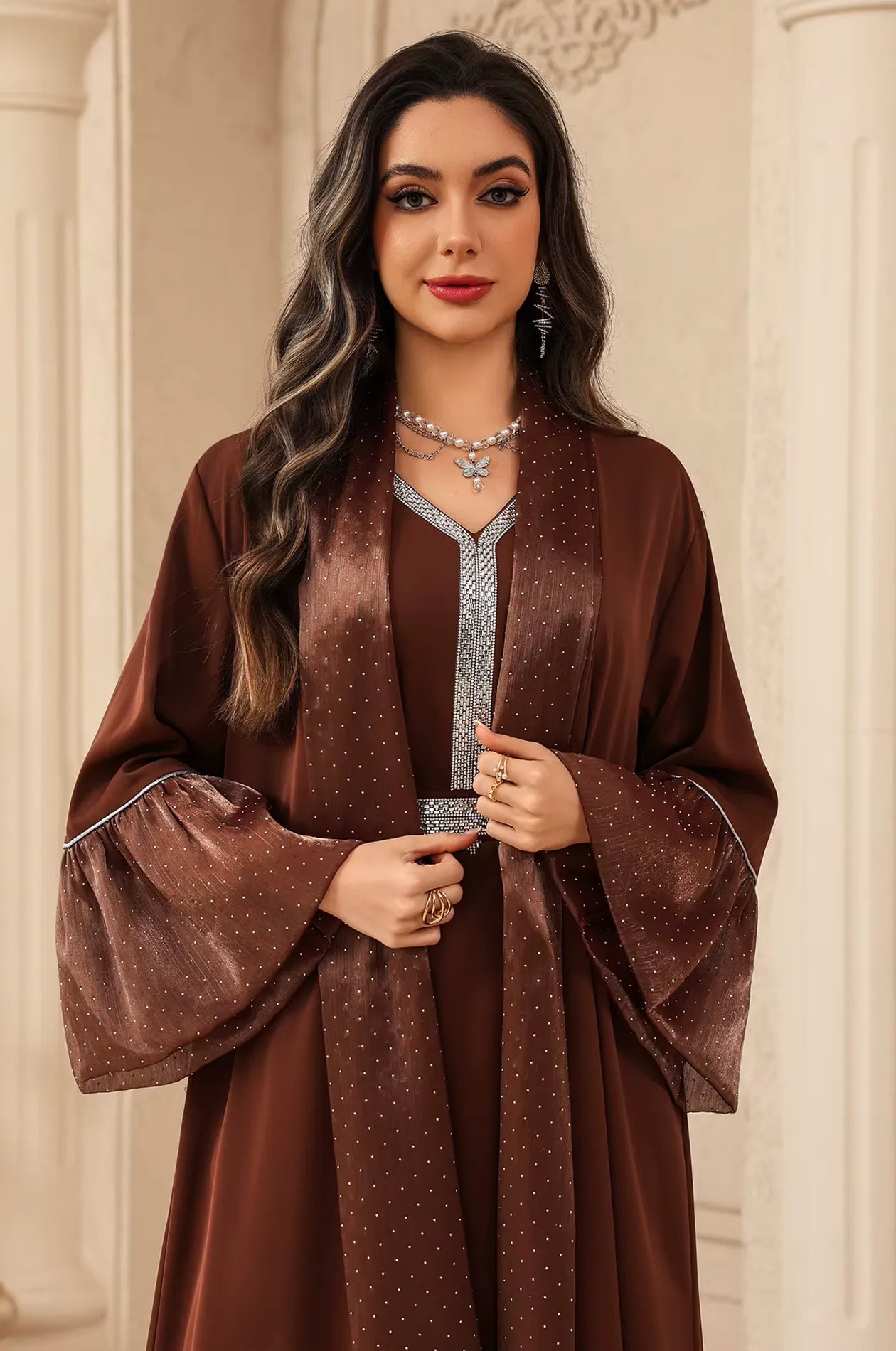 Close-up of the Auris Brown Kaftan bodice showing the intricate silver rhinestone embroidery on the V-neck and belted waist.