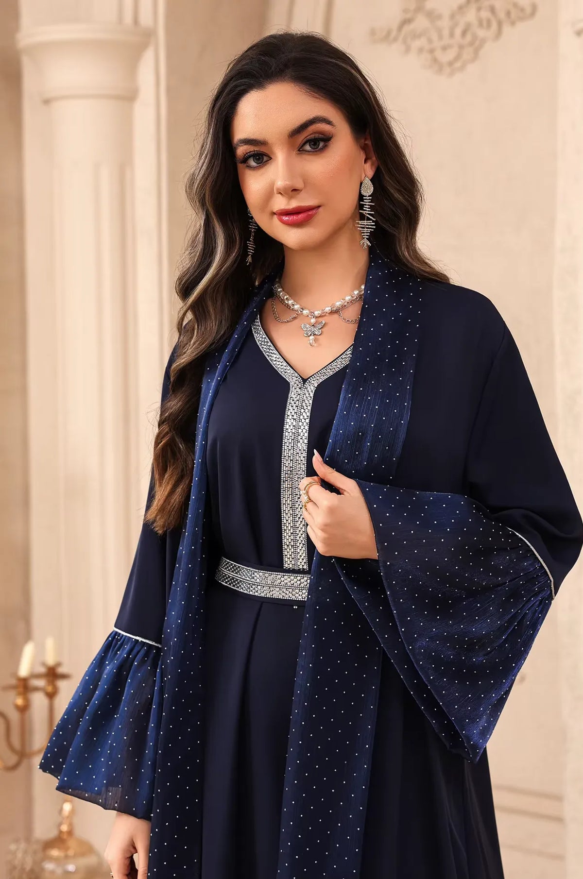 Portrait view of the Auris Blue solid color Kaftan highlighting the silver rhinestone trim on the neckline and matching belt.