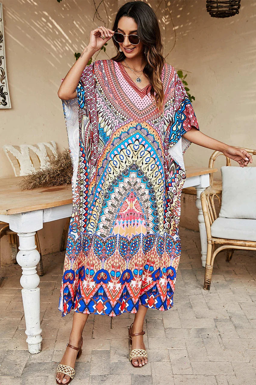Model wearing Avani kaftan indiano with vibrant boho print on porch