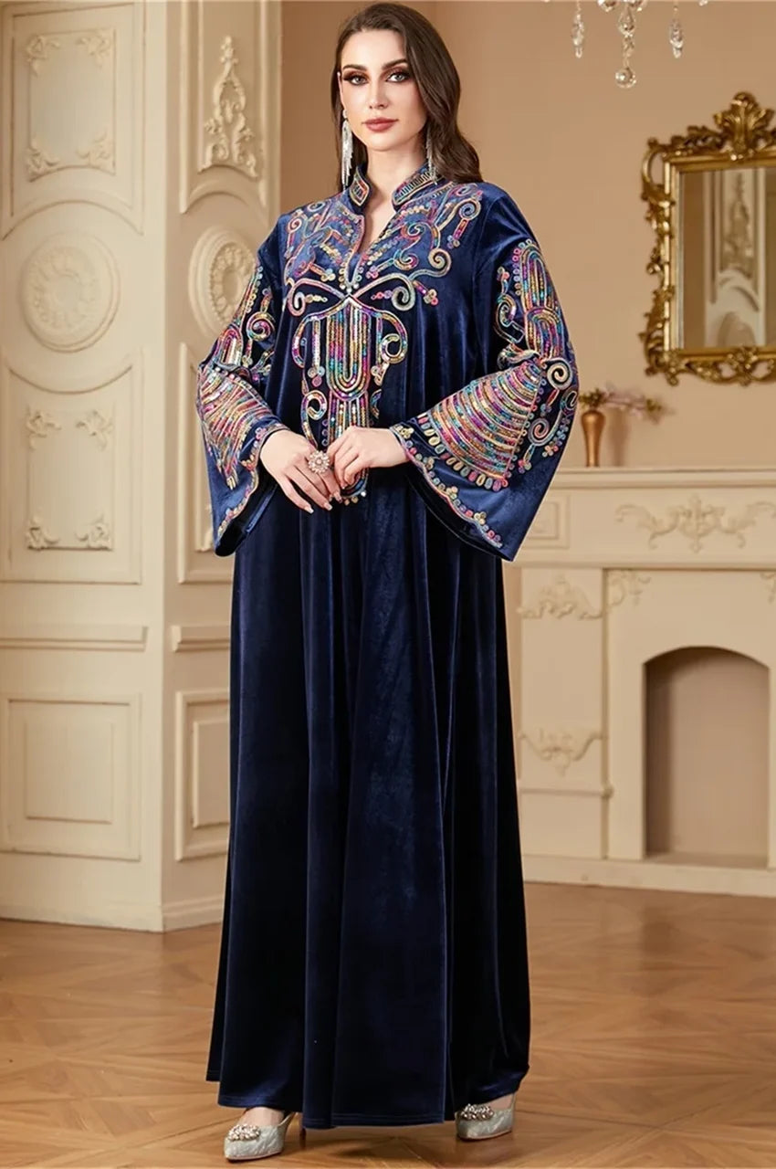 Model wearing Avela Navy Blue velvet kaftan long dress with sequin details.