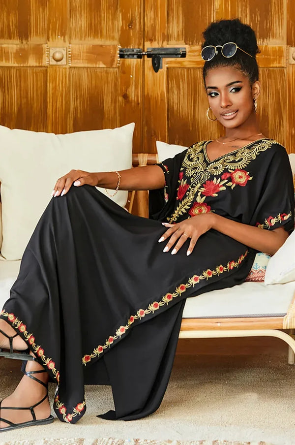 Aylen black embroidered kaftan styled in a relaxed seated look