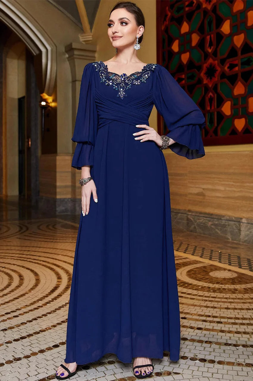 Full-length indoor view of Aylin navy blue kaftan in luxury setting
