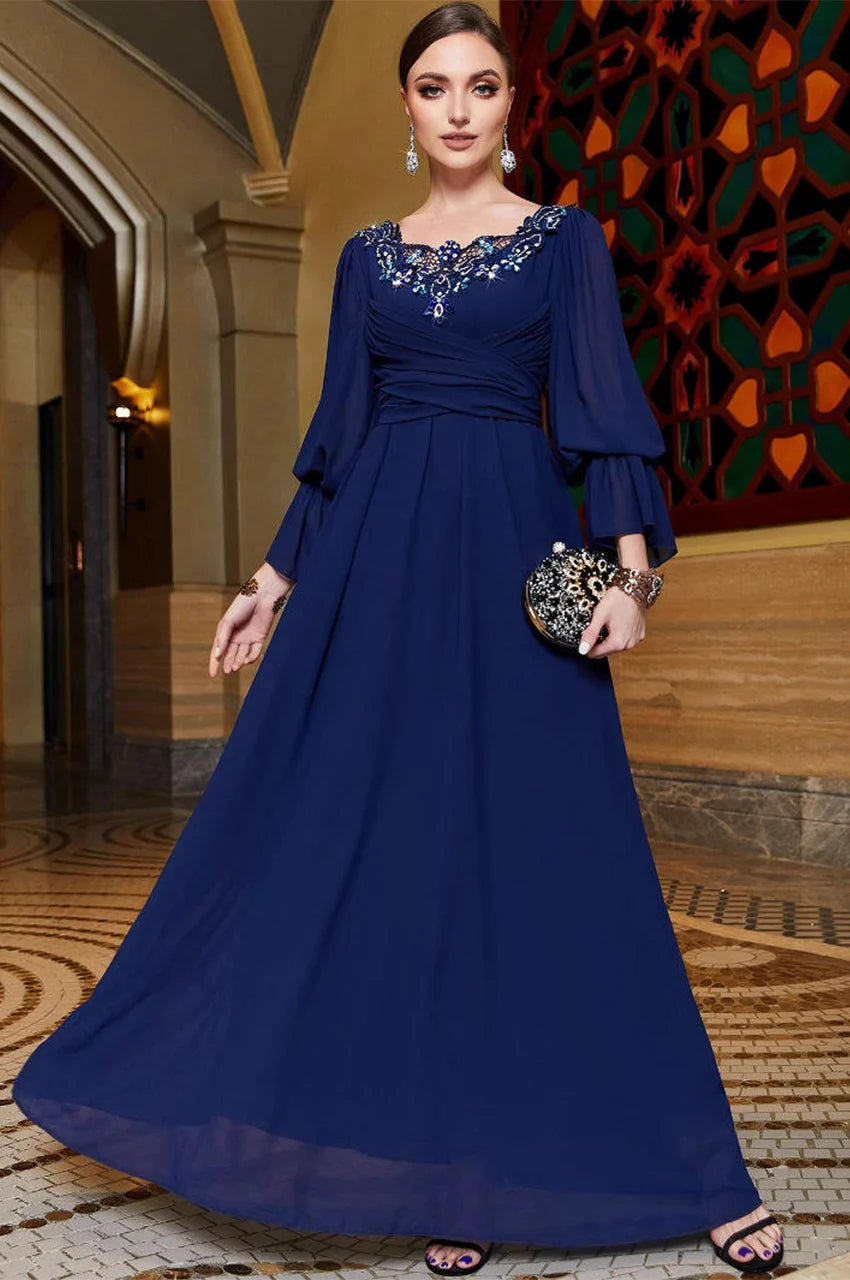 Aylin navy blue kaftan in motion showing flowy hem and elegant silhouette
