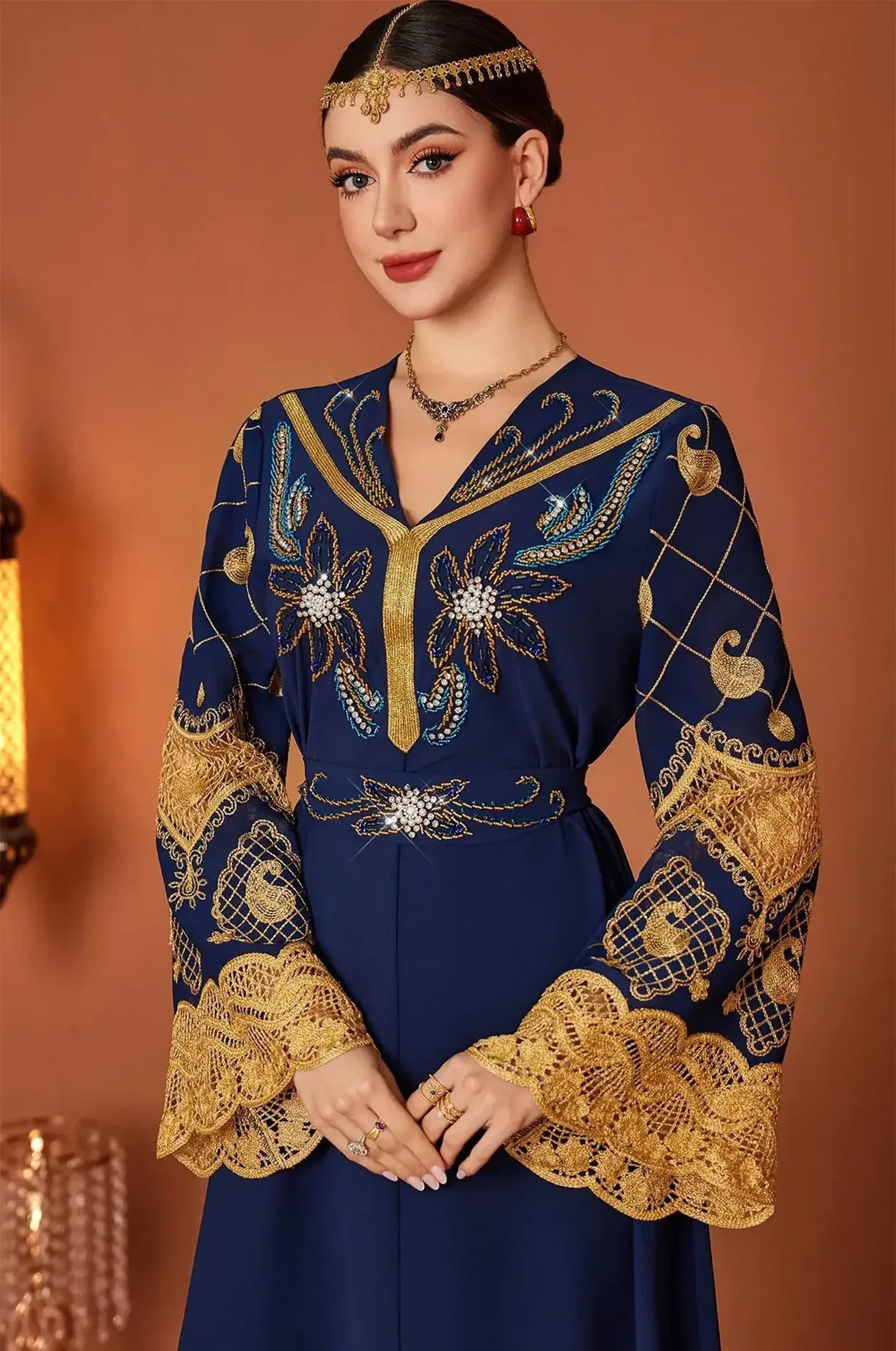 Portrait view of the Aysel kaftan focusing on the V-neckline and headpiece.