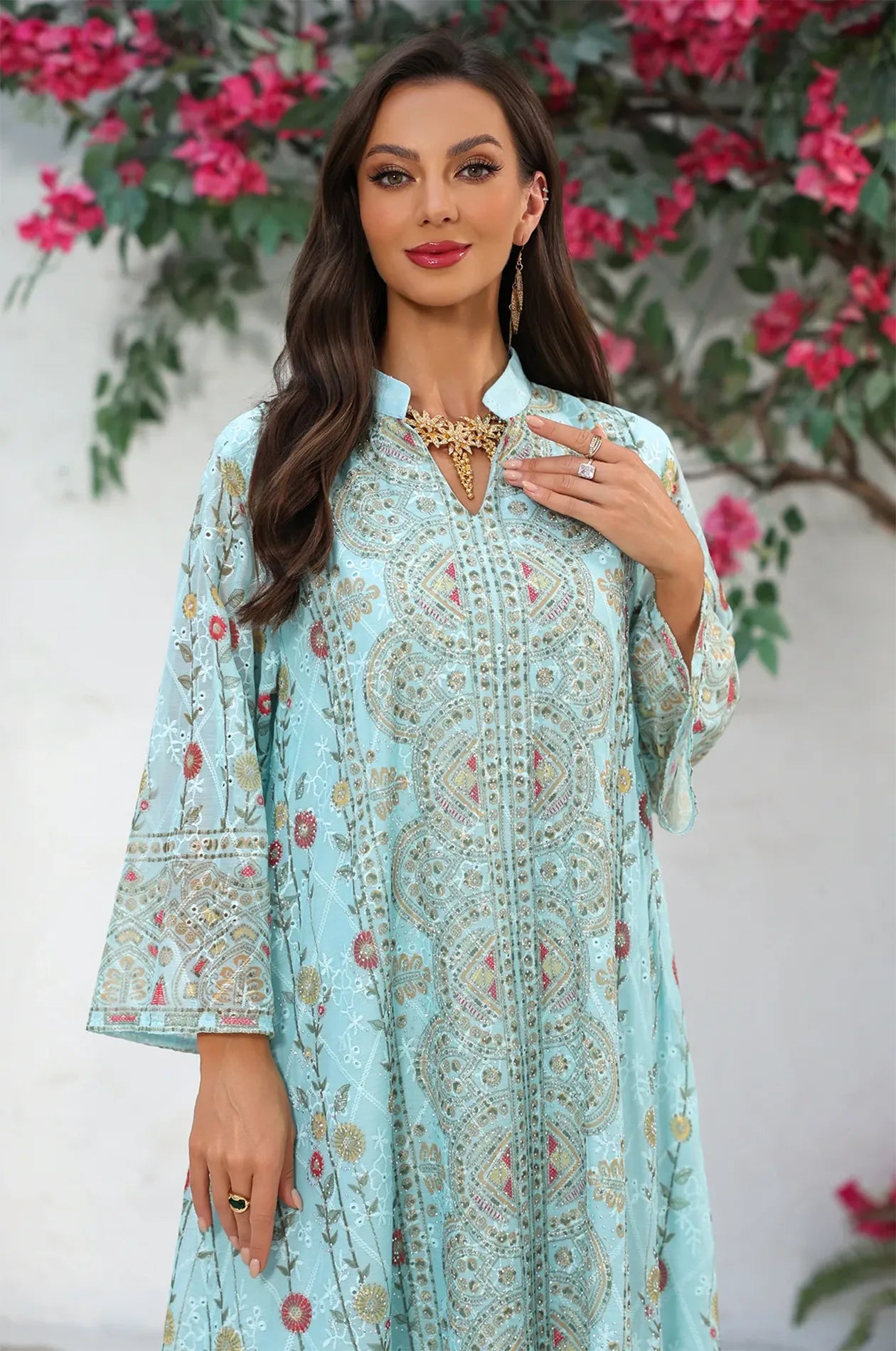 Close-up detail of the intricate geometric and botanical print on the bodice of the Azari mint green chiffon kaftan.