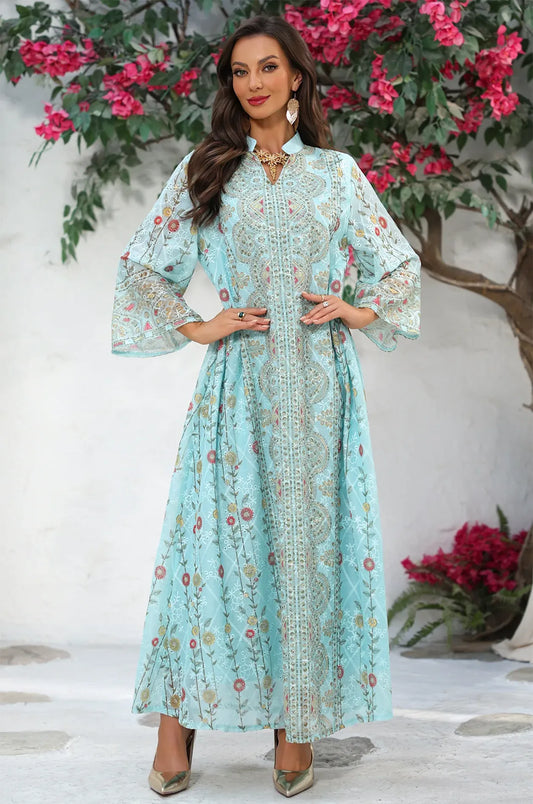 Model posing in the Azari mint green chiffon kaftan maxi dress highlighting the bell sleeves and breezy high-density chiffon fabric.