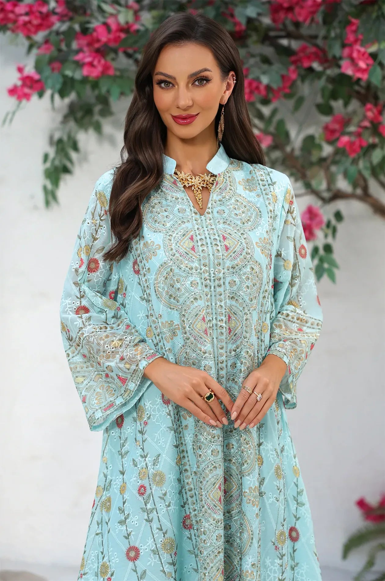 Detailed view of the split V-neckline and decorative patterns on the mint green Azari chiffon kaftan for a sophisticated look.