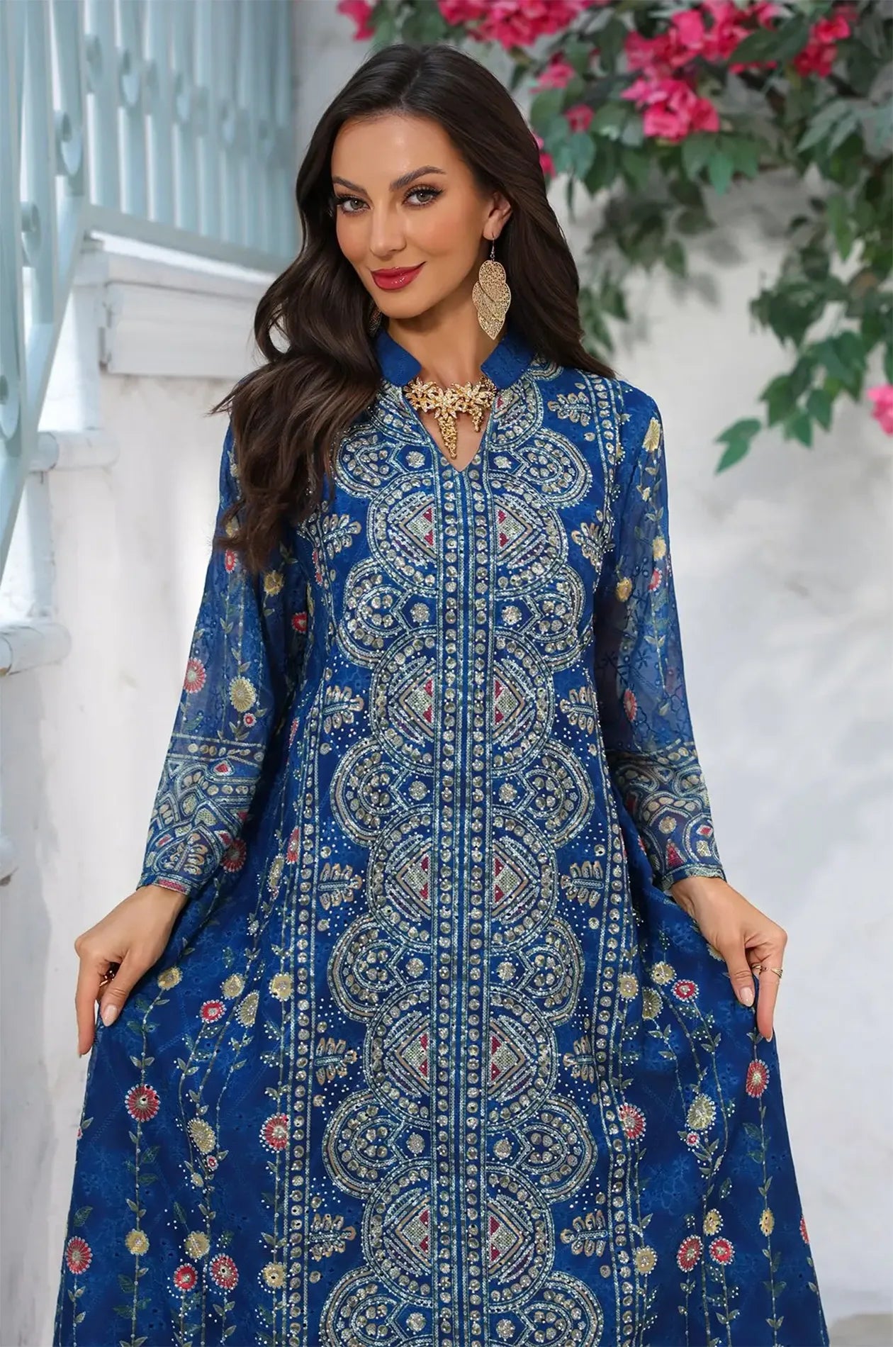 Detailed view of the decorative patterns and bell sleeves on the navy blue Azari chiffon kaftan for a sophisticated look.